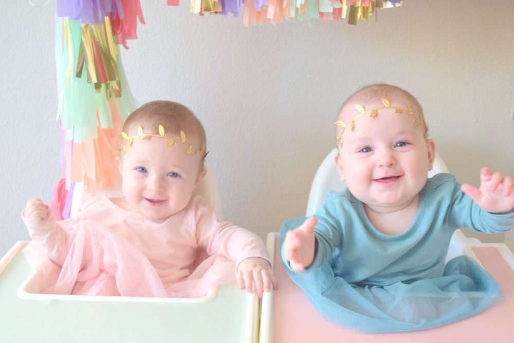 Six Month Pictures Twin girls Monthly baby pictures gold headband colorful tassel garland