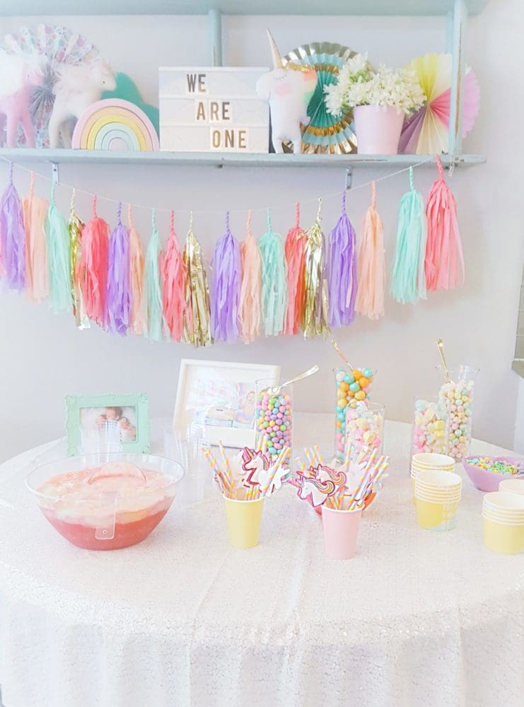 A pretty pastel unicorn first birthday party including pastel unicorn tassel garland rainbow punch pastel unicorn candy bar and many more unicorn centerpiece ideas and unicorn backdrop ideas for unicorn party ideas on a budget