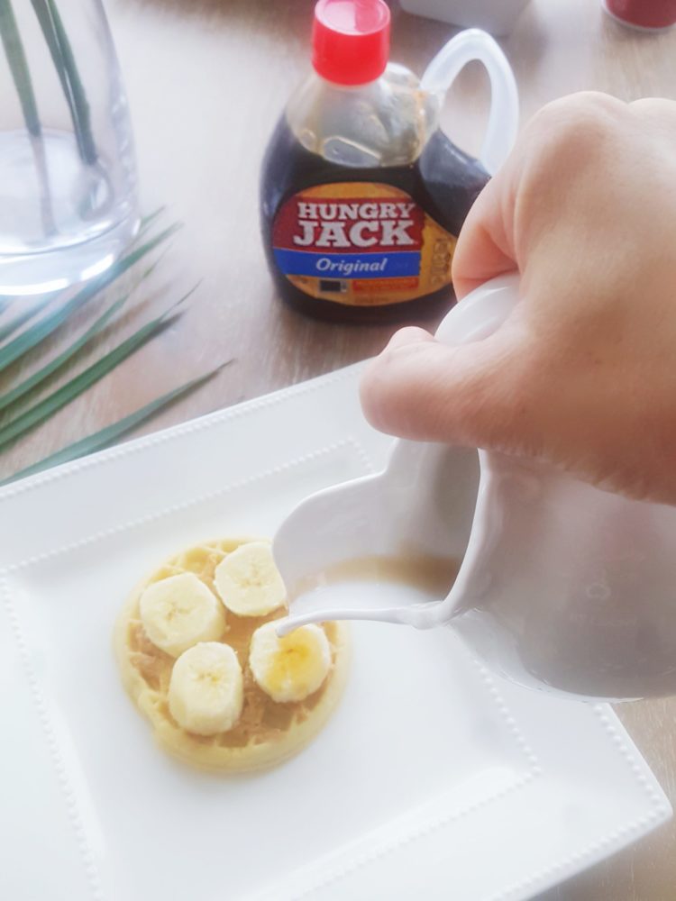Eggo Waffle with peanut butter and banana and maple syrup