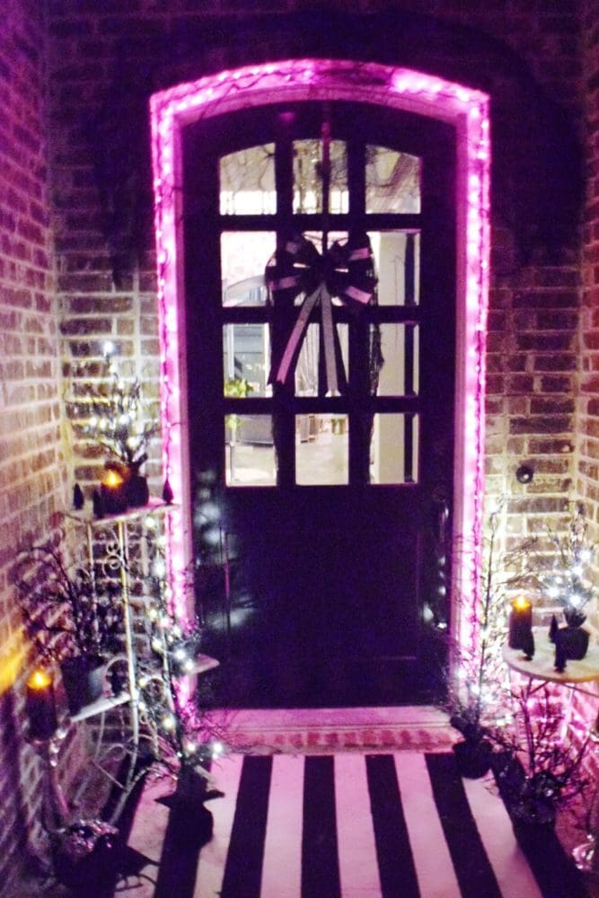 Frightful front porch pink purple halloween lights around front door