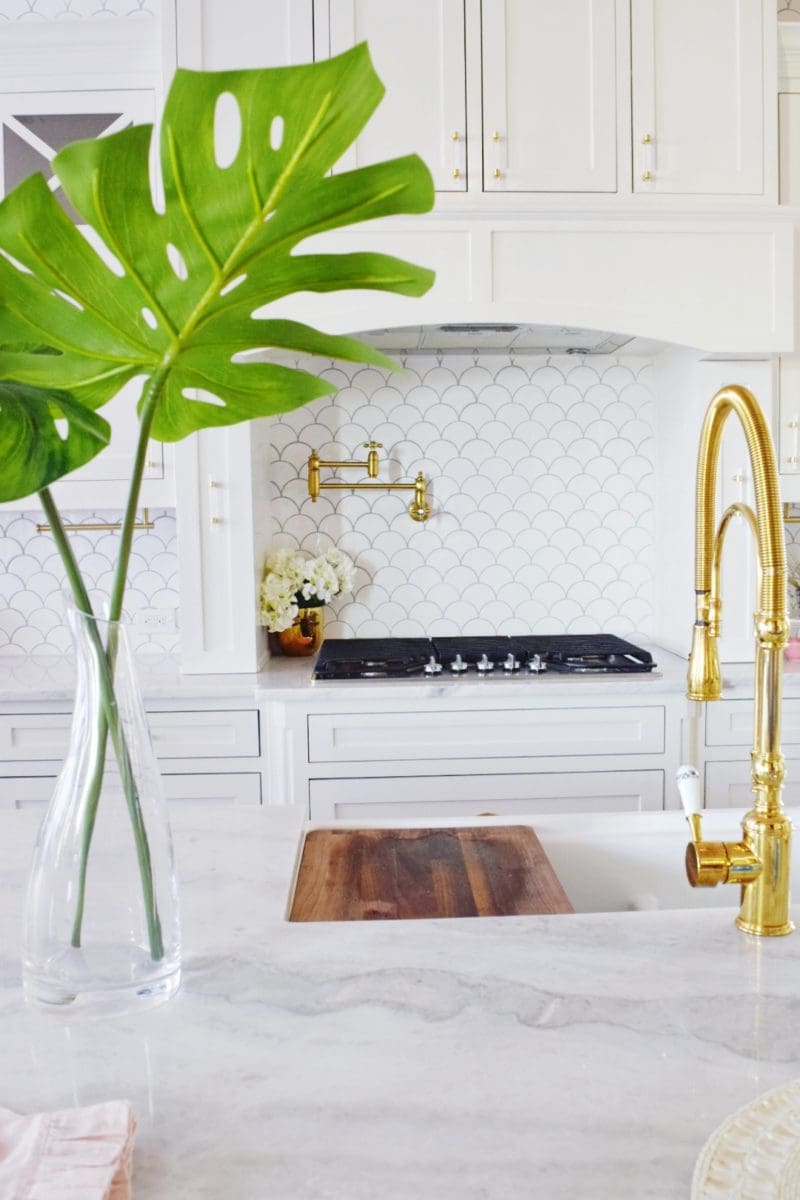 Modern Coastal Glam Kitchen Makeover Coastal Kitchen Design Ideas white farmhouse sink marble countertops marble kitchen island brass faucet brass pot filler coastal backsplash white backsplash allegro white fan tile jeffrey court white fan tile