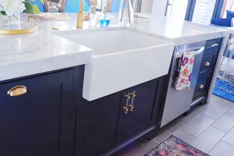 The Reveal: Modern Coastal Glam Kitchen Makeover Farmhouse Sink Navy Island Marble Countertops Brass Hardware Brass Faucet glam kitchen ideas glam kitchen décor modern coastal kitchen modern kitchen cabinets modern kitchen island modern kitchen ideas