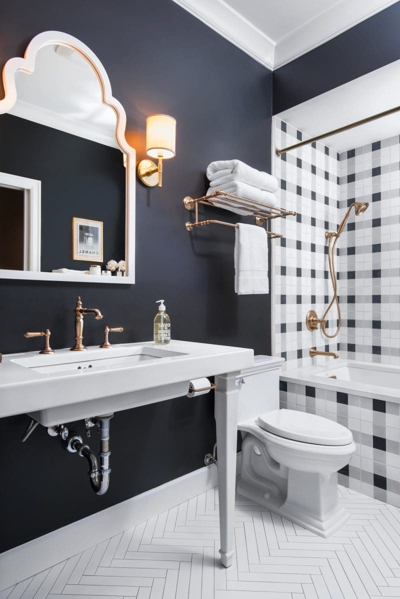 Caitlin Wilson Guest Bathroom Patterned cement floor tiles Kohler Navy and white check tile Kohler Artifacts Hotelier Kohler Artifacts Rite Temp Valve Trim Kohler Artifacts Bath Spout Kohler Forte Handshower Kohler Awaken Shower Hose