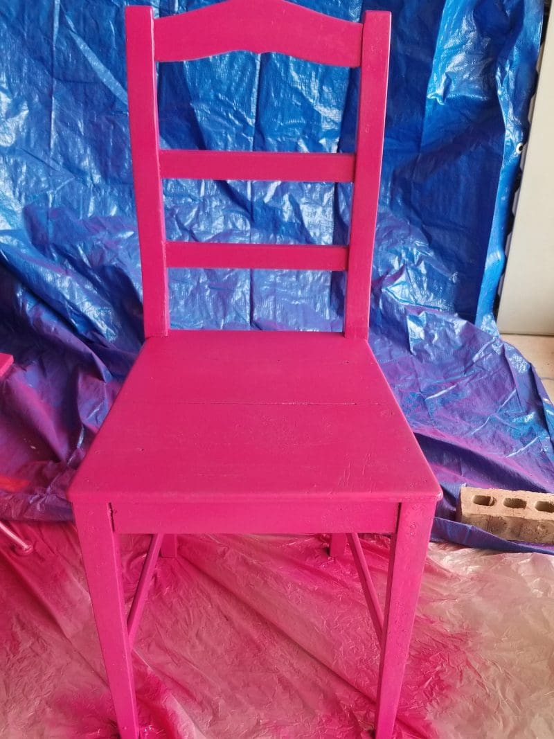 spray painting a pink chair