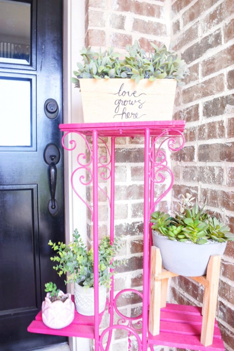 bright pink patio furniture with plants on front porch