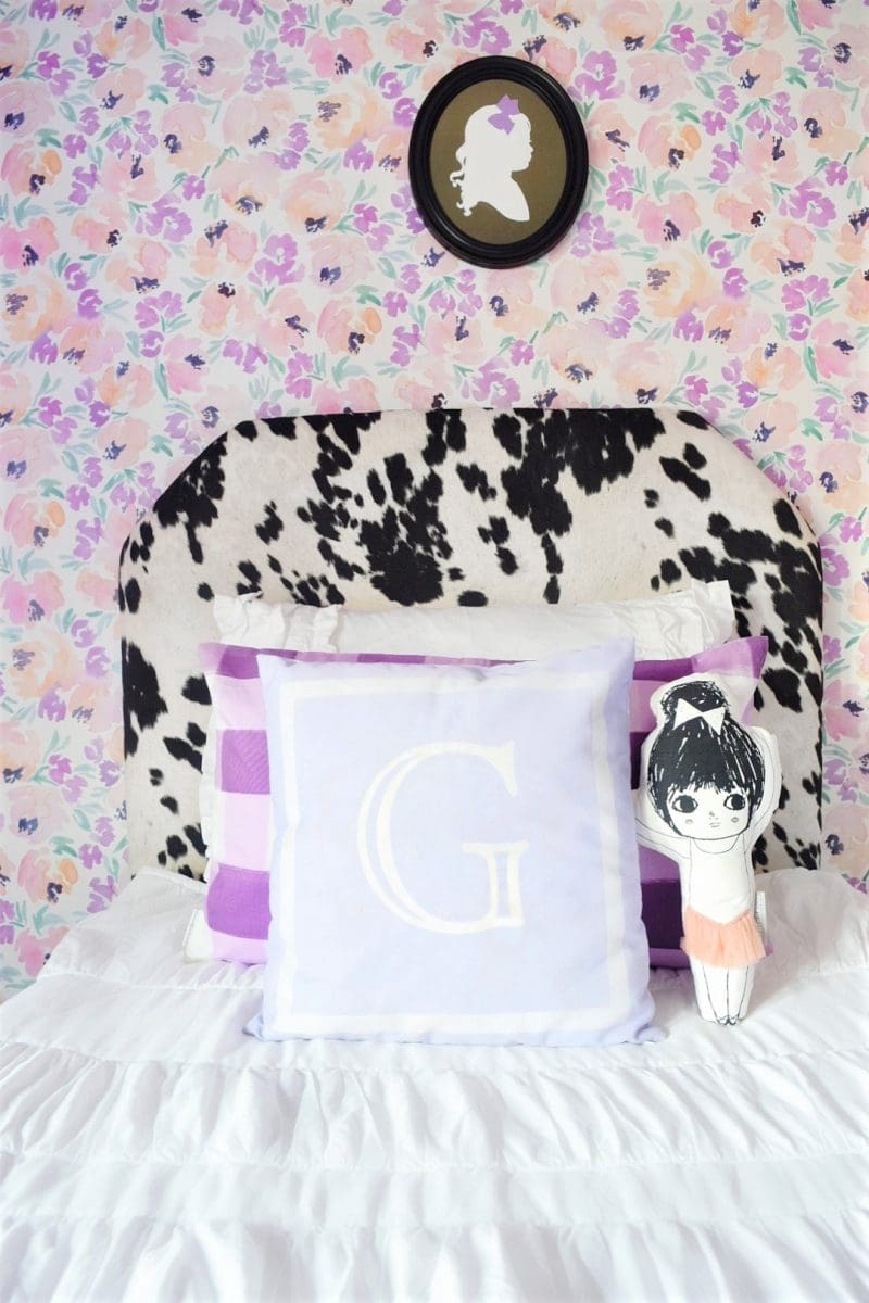 whimsical chic little girls room with peony wallpaper monogram pillow and black cowhide headboard