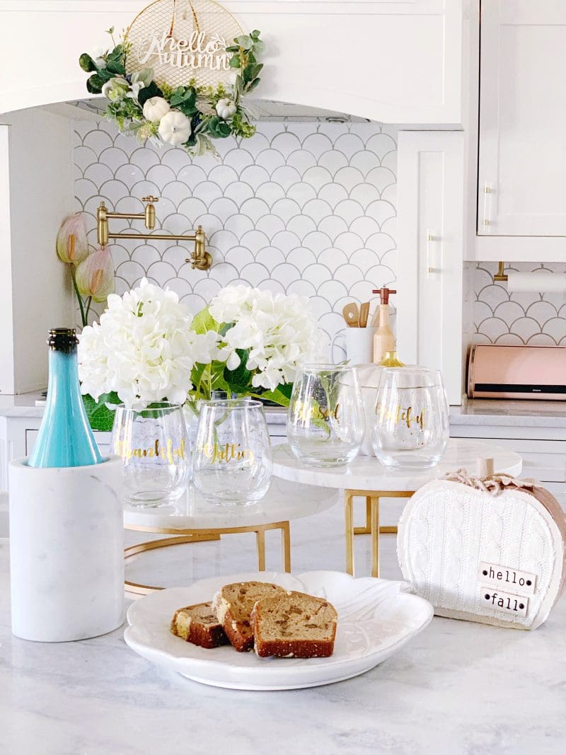 white kitchen cabinets and kitchen backsplash with white and gold fall decor