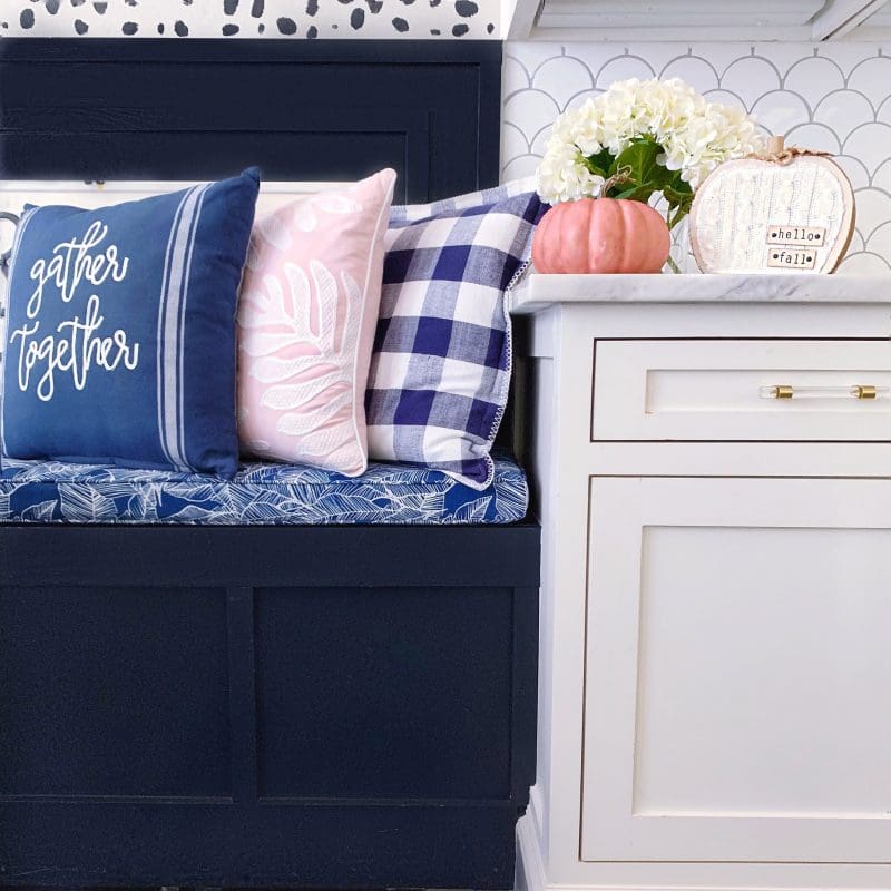 breakfast nook with built in bench and fall pillows and pumpkins