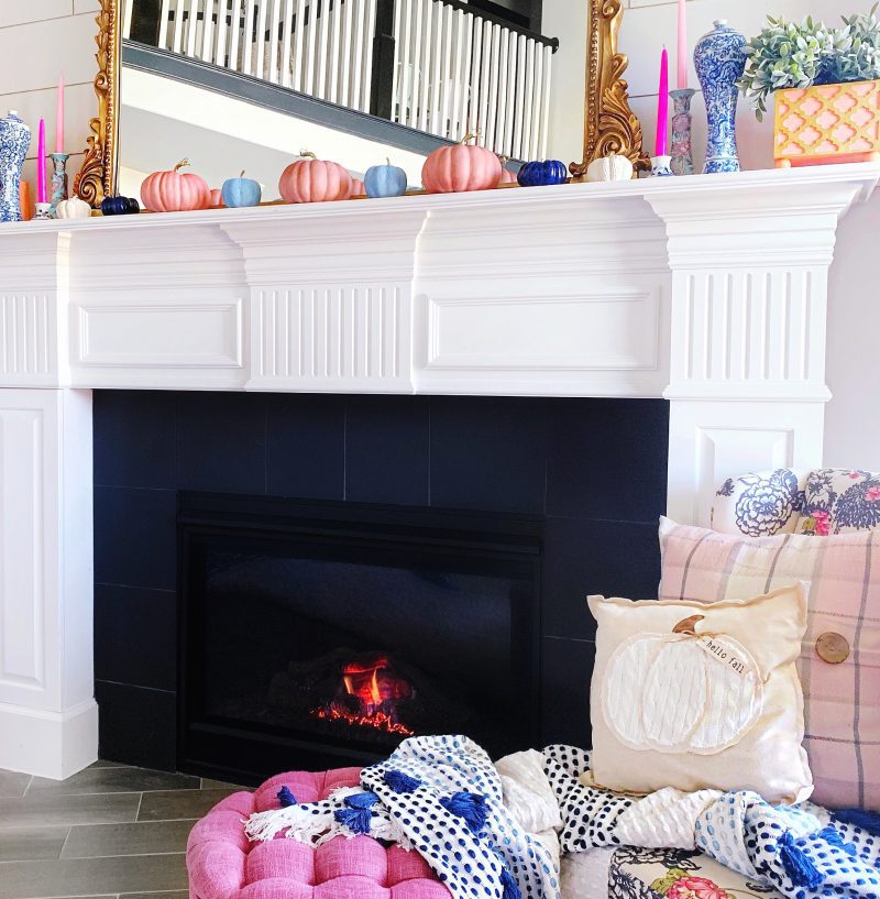 colorful fall mantle with candles and pumpkins