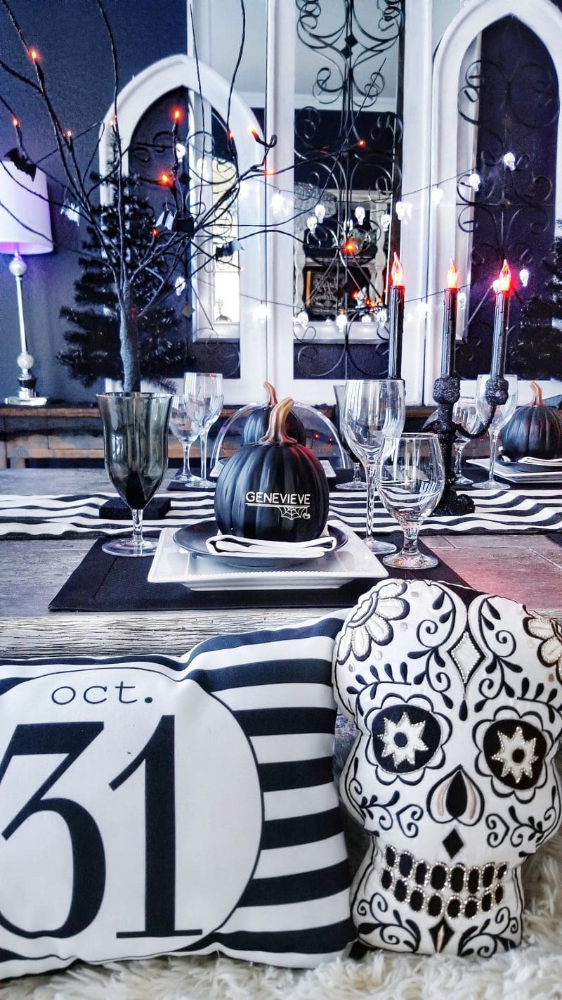 halloween dinner party with black and white striped napkins and placemats and black and white halloween pillows