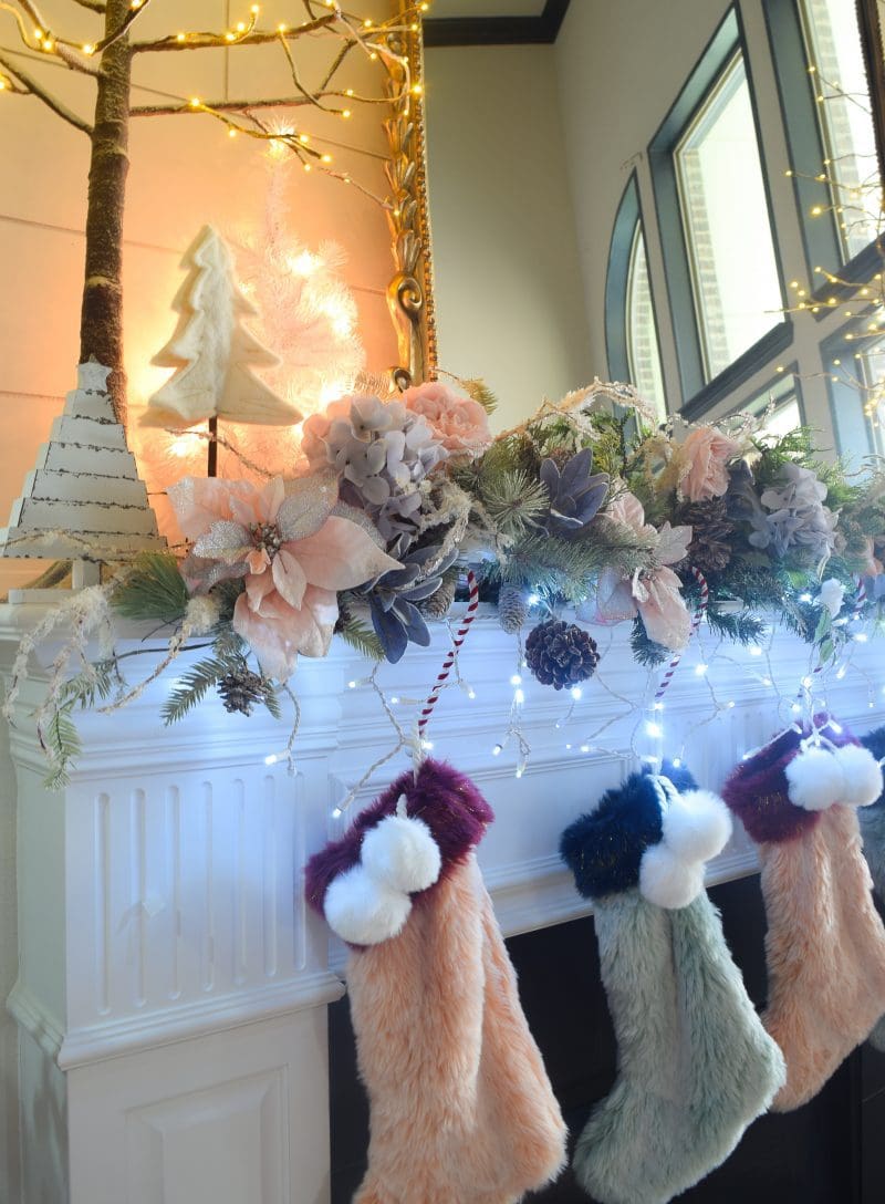 fur christmas stockings and christmas garland on mantel