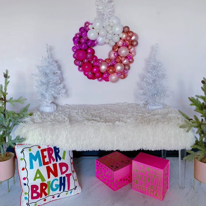 pink christmas wreath with white christmas trees pink christmas gift boxes and christmas pillow