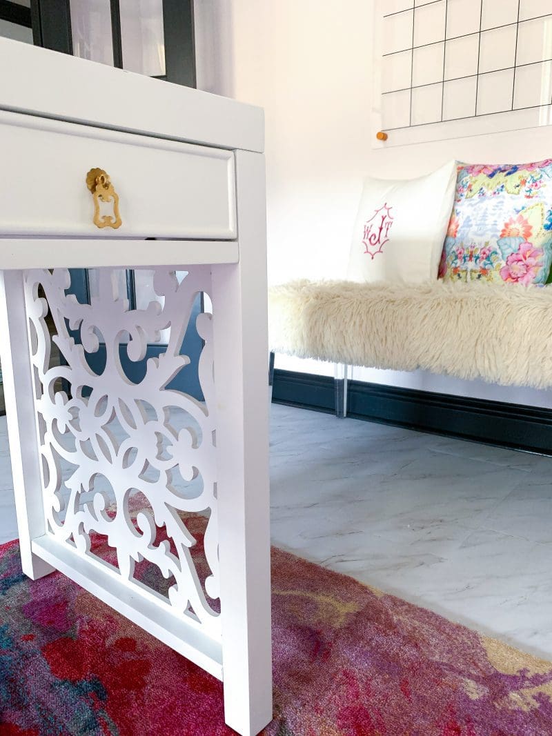 home office with white modern desk pink rug and fur bench