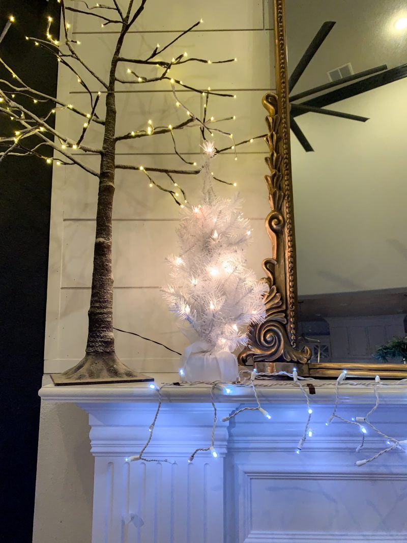 lighted christmas trees on mantel