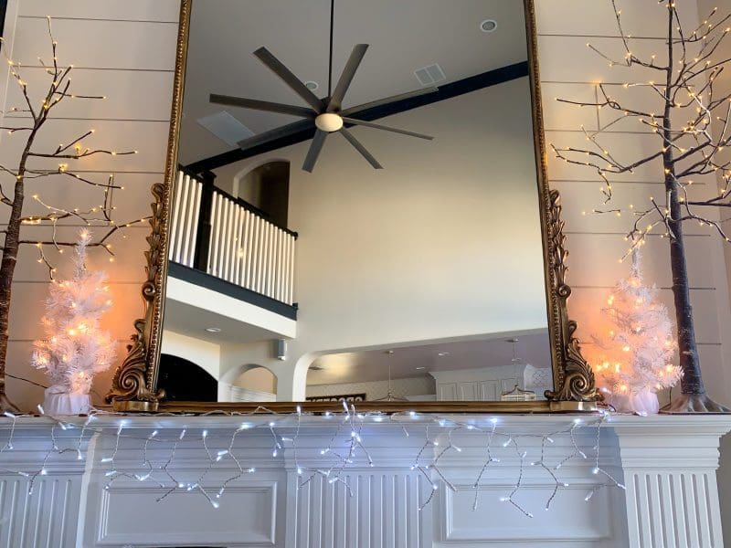 white mantel shiplap wall with christmas trees and mirror