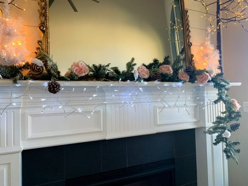 christmas fireplace mantel adding garland