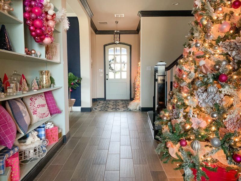 pink christmas decor on christmas tree and entryway