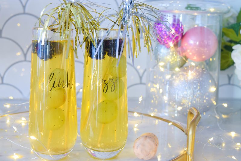 Shimmery New Years eve cocktail with firework stirrer sticks