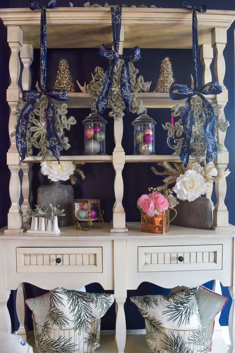 navy wall white display piece in dining room with navy and pink christmas decorations