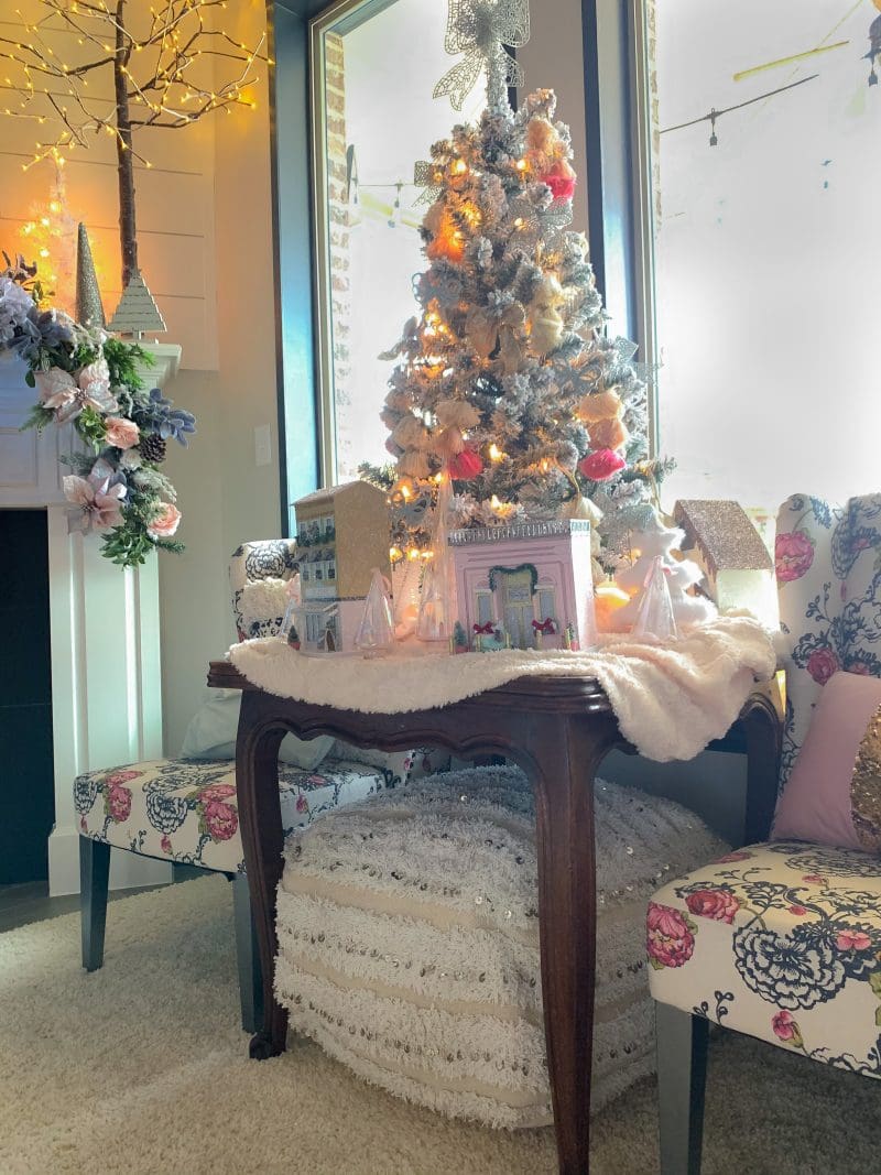 pink and white christmas tree with light up paper houses 